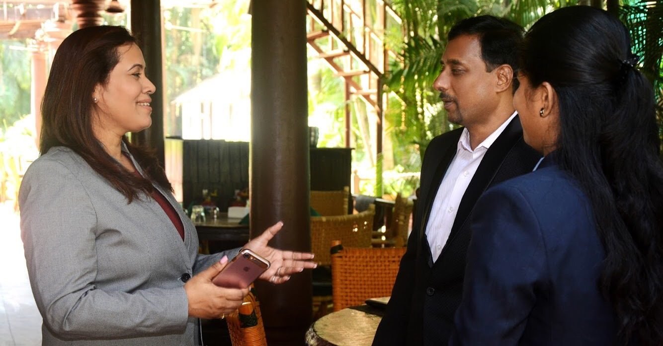 Kalpana Khot speaking with two colleagues